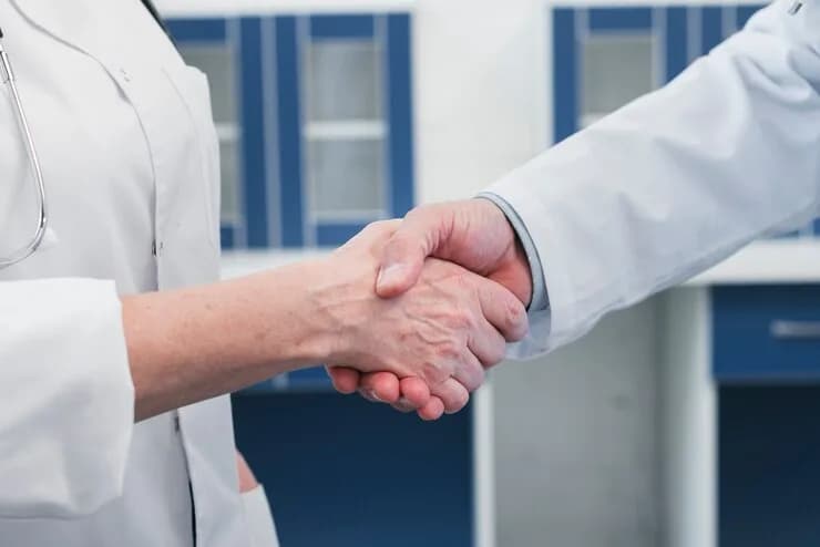 Medical professionals shaking hands