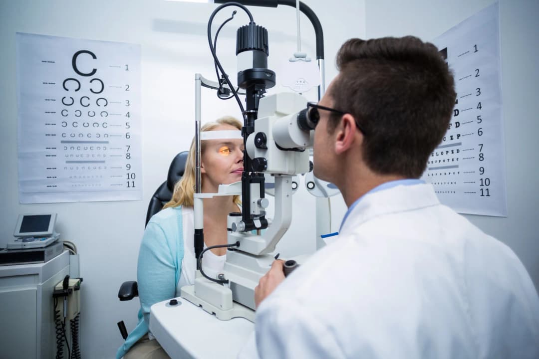Optometrist examining patient's eyes